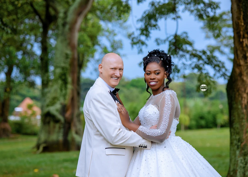 Newly married couple holding hands in a garden